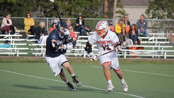 Brother Rice’s Morgan Macko takes the ball upfield against Cranbrook’s Tag Bertuzzi earlier this week. Macko scored five times in last year’s title game for the Warriors, who have won the state championship every year since MHSAA began recognizing the sport in 2005.