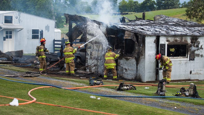 Firefighters respond to the scene of a structure fire in Dooms on Monday, June 22, 2015. 