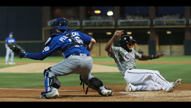 El Paso’s Manuel Margot scores the Chihuahuas’ first run Monday as Las Vegas catcher Kevin Plawecki catches a throw from the outfield.