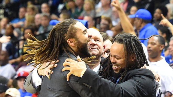 Former Robert E. Lee's head coach Jarrett Hatcher, center, celebrates his team's state championship victory last March with assistants Terrell Mickens, left, and Teley Tate. Mickens is now the interim coach of the team following Hatcher's suspension.