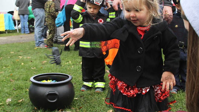 Brynn Husman enjoys playing the spider toss game at Menominee Park Zoo's Zooloween Boo in 2014.