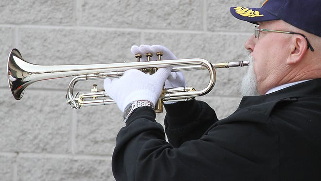Dec. 7 is Pearl Harbor Remembrance Day and in respect for those who served the AMVETS Post No. 7 will hold a ceremony in their honor. Mark Radl, pictured, finished the ceremony playing taps in this file photo from 2014.