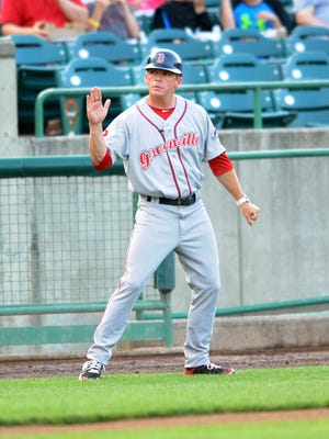 Greenville Drive manager and Middletown South alum Darren Fenster coaches third base at FirstEnergy Park on Saturday.