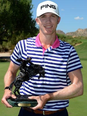 RJ Woods holds the trophy for the 71st Arizona Open.