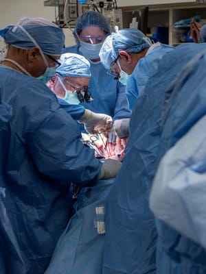 In this Wednesday, Feb. 24, 2016, photo provided by Cleveland Clinic Center, a team of Cleveland Clinic transplant surgeons and gynecological surgeons perform the nations first uterus transplant during a nine-hour surgery in Cleveland. In a statement Thursday, the Cleveland Clinic said the surgery was performed on a 26-year-old woman, using a uterus from a deceased donor. (Cleveland Clinic Center via AP)