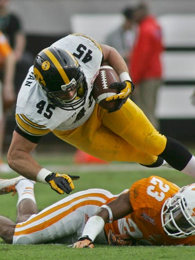 Former Iowa Hawkeyes running back Mark Weisman, top,