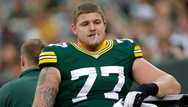 Green Bay Packers' Aaron Adams is carted off the field after getting injured in the first quarter.