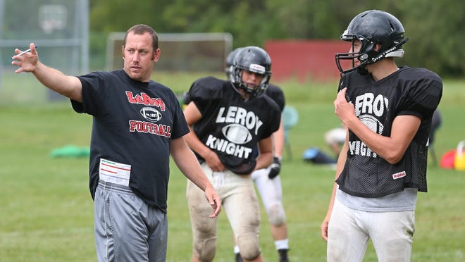 New Le Roy head coach Brian Herdlein goes over secondary coverage with safety Ryan Boyce during practice at Le Roy High School Wednesday.