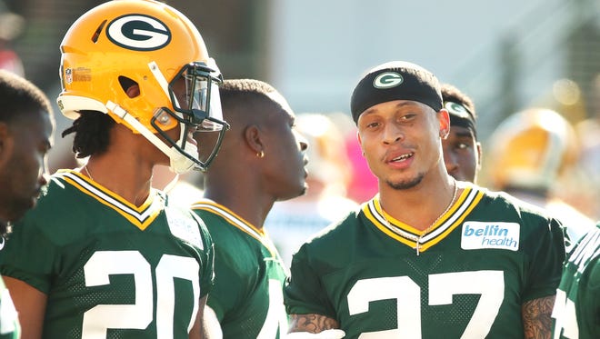 Green Bay Packers safety Josh Jones (27) talks with cornerback Kevin King (20) during training camp Thursday, July 27, 2017, at Ray Nitschke Field.
