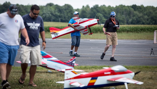 Model airplanes take to the air at the Academy of Model Aeronautics grounds.