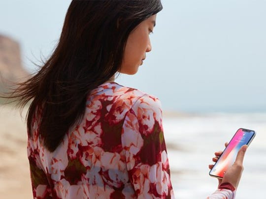 Woman using Face ID on a beach