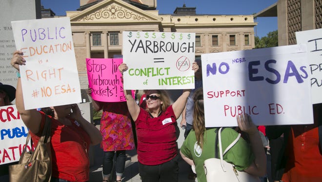 Protesters rally against an expanded school voucher program, as Arizona lawmakers prepare to advance legislation that would do just that, at the Arizona State Capitol in Phoenix on April 6, 2017.