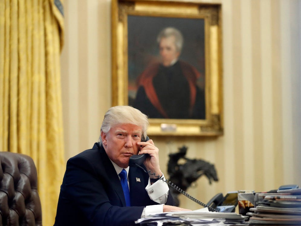 In this Jan. 28, 2017, file photo, President Trump speaks on the phone in the Oval Office of the White House.