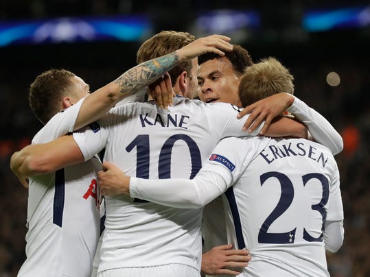 Tottenham's Dele Alli, rear, and Tottenham's Harry Kane hug teammate Christian Eriksen, right, who scored his side's third goal during a Champions League Group H soccer match between Tottenham Hotspurs and Real Madrid at the Wembley stadium in London, Wednesday, Nov. 1, 2017. (AP Photo/Matt Dunham)
