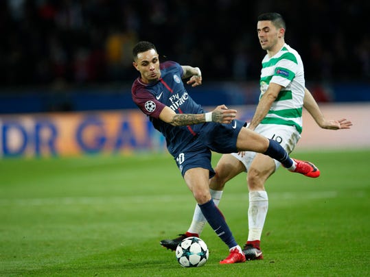 PSG's Layvin Kurzawa, left, is challenged by Celtic's Thomas Rogic during a Champions League Group B soccer match between Paris St. Germain and Celtic at the Parc des Princes stadium in Paris, France, Wednesday, Nov. 22, 2017. (AP Photo/Christophe Ena)