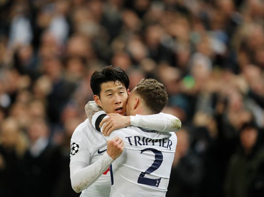 Tottenham's Son Heung-min, left, celebrates after scoring the opening goal with his teammate Kieran Trippier, during the Champions League, round of 16, second-leg soccer match between Juventus and Tottenham Hotspur, at the Wembley Stadium in London, Wednesday, March 7, 2018. (AP Photo/Frank Augstein)
