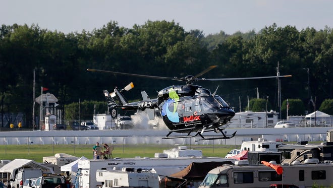 A helicopter lifts off at Pocono Raceway carrying race car driver Justin Wilson, of England, after he was involved in a crash during the Pocono IndyCar 500 auto race Sunday, Aug. 23, 2015, in Long Pond, Pa.