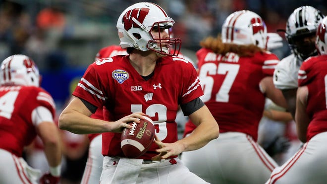 Badgers quarterback Bart Houston looks to pass during the Cotton Bowl.