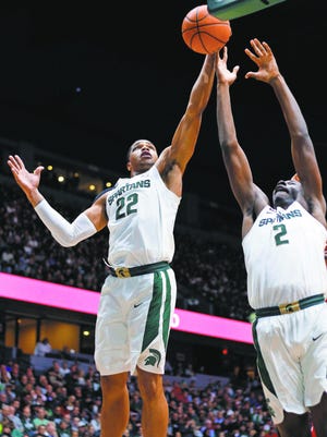 Michigan State's Miles Bridges, left, and Jaren Jackson Jr., right, battle for a rebound during a game earlier this season.