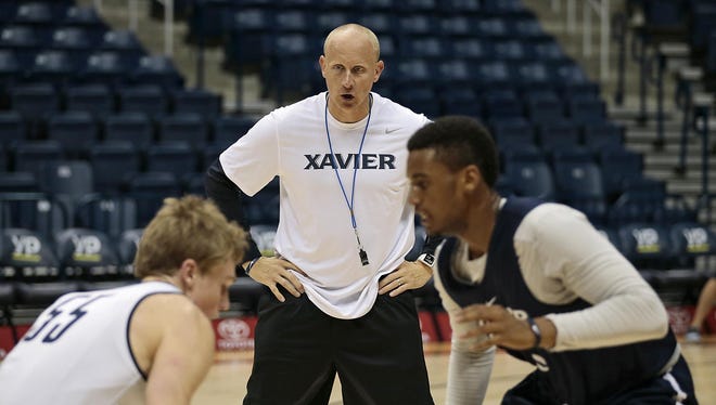 Xavier coach Chris Mack directs a drill during a team workout Monday at Cintas Center. The Musketeers reached the Sweet 16 in last season’s NCAA basketball tournament.