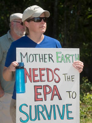 Kathy Jensen joins the hostile crowd gathered on Thursday, April 20, 2017, at the American Creosote Works Superfund site in Pensacola to challenge Congressman Matt Gaetz about his bill to abolish the U.S. Environmental Protection Agency.