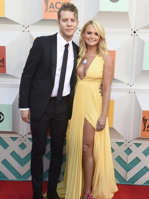 Anderson East, left, and his girlfriend Miranda Lambert pose on the red carpet at the 51st Academy of Country Music Awards.