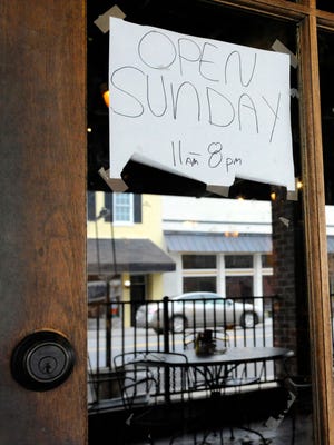 This photo taken Tuesday, Nov. 17, 2015, shows the "Open Sunday" sign outside Marble City Grill in Sylacauga, Ala., where voters recently decided to legalize alcohol sales on Sunday. The change is part of a broad pattern across the South as churches lose their grip on a region where they could long set community standards. (AP Photo/Jay Reeves)