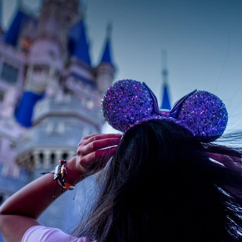 A guest approaching Disney World's castle wearing 