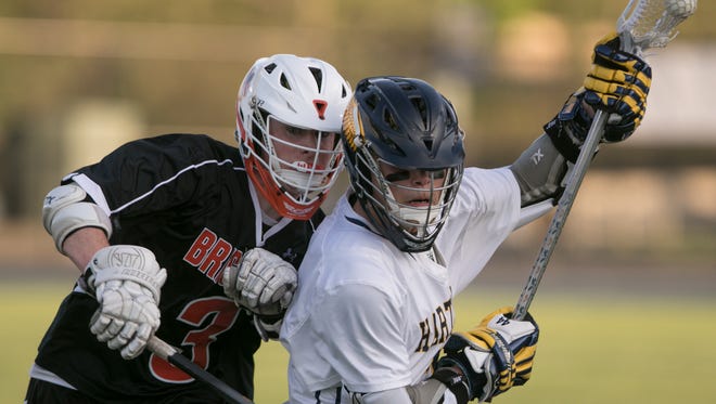 Brighton’s Trent Salmon guards Hartland’s Reece Potter, who scored four goals and had an assist in a 15-4 victory on Wednesday, May 16, 2018.