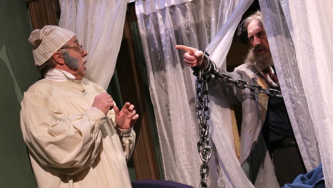 Bruce Jacklin (left), as Ebenezer Scrooge, is haunted by Marley, played by David Holbrook during a rehearsal last year at the Mansfield Playhouse, which will be celebrating its 50th anniversary next season.