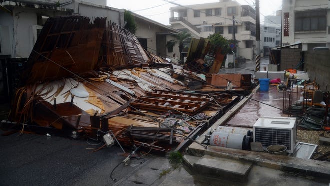 A wooden house collapsed during strong winds on Okinawa on July 8 as powerful Typhoon Neoguri lashed Japan.