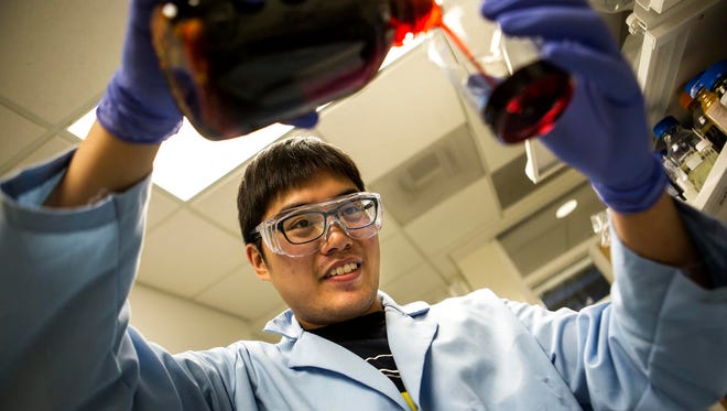 Siu On Tung, a doctoral student at the University of Michigan and a member of Professor Nick Kotov's research group, works on a battery that will be used in Elegus Technologies’ product.