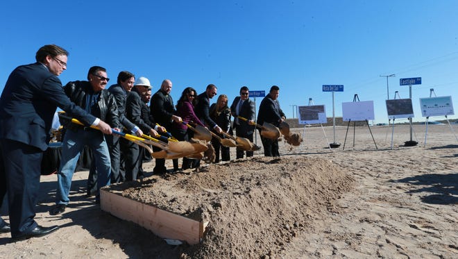 County and regional leaders turn over shovelfuls of dirt Tuesday at Paseo del Este Drive and Mission Ridge Boulevard for a groundbreaking ceremony for eight major road construction projects.