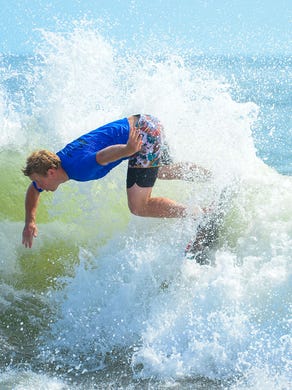 Sam Stinnett, Dana Point, Ca., catches a wave during the Men's Pro Division heat in the semifinals of the Skim USA Association ZAP Pro/Am Skimboarding Competition in Dewey Beach, De. on Friday, August 11, 2017.