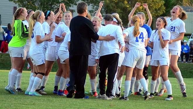 White House High players and coaches celebrate after the Lady Devils' 3-1 victory over Page in Saturday's Class A-AA sectional match.