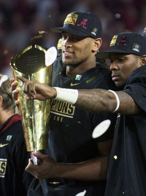 Alabama tight end O.J. Howard (88) and defensive back Eddie Jackson (4) celebrate with the championship trophy following the College Football Playoff Championship Game on Monday January 11, 2016 at University of Phoenix Stadium in Glendale, Az. (Mickey Welsh / Montgomery Advertiser)