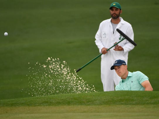 Jordan Spieth hits from a bunker on the 2nd hole during