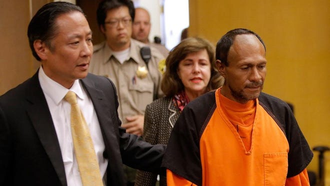 Juan Francisco Lopez-Sanchez enters court for an arraignment with public defender Jeff Adachi, left, on July 7, 2015, in San Francisco. He pleaded not guilty in a fatal shooting.