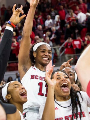 North Carolina State's Kiara Leslie (11) celebrates with her teammates following a victory in a second-round game in the NCAA women's college basketball tournament against Maryland in Raleigh, N.C., Sunday, March 18, 2018. North Carolina State defeated Maryland 74-60. (AP Photo/Ben McKeown)