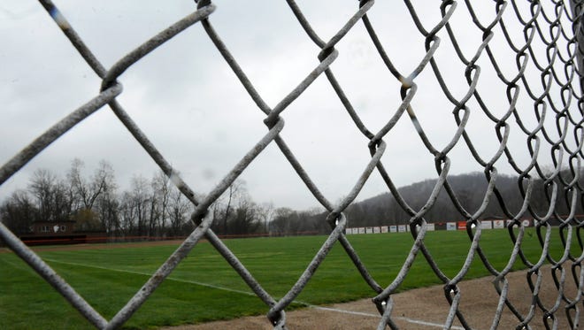 Rain clings to the outfield fence at Heath High School's Dave Klontz Field on Friday, April 8, 2016. For the second consecutive day, the county's entire baseball schedule was postponed because of the intermittent precipitation and unseasonably cold temperatures.
