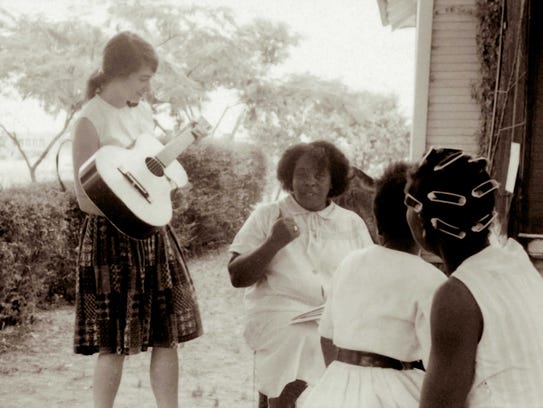 Fannie Lou Hamer, center, chats with Heather Booth,