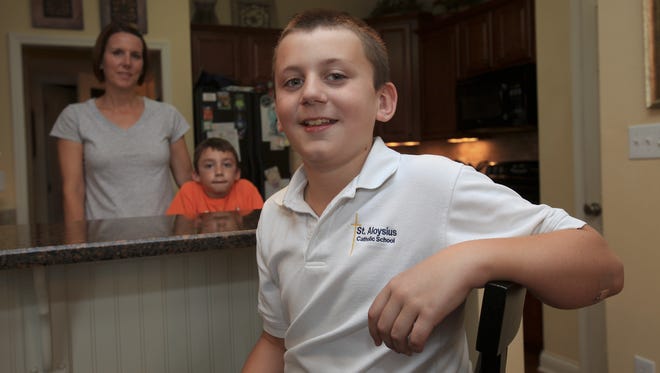 Ben Dickison, 11, of Crestwood, is allergic to tree nuts. His family includes his mom, Angie Dickison, left, and brother Blake, pictured behind him.