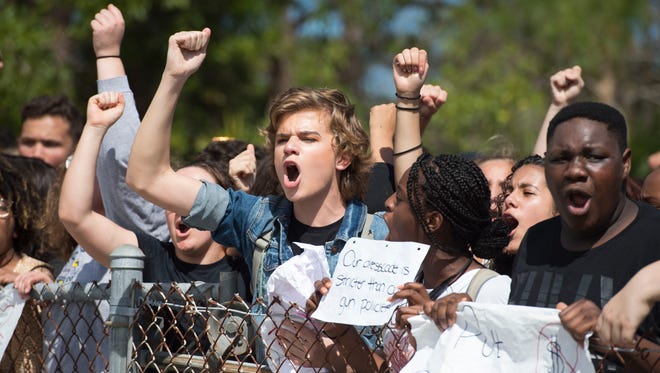 "It needs to stop," said Farrah Rivera, 15, a sophomore of Port St. Lucie, as at least 100 Port St. Lucie High School students made their way to the front gates of the school in a peaceful protest honoring the 17 slain Marjory Stoneman Douglas High School students on Wednesday, Feb. 21, 2018 at the school in Port St. Lucie.