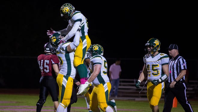 Horizon offensive tackle Jake Grant hoists wide receiver Nick Lylyk up into the air after Lylyk caught a touchdown pass against Boulder Creek on Friday, Oct. 17, 2014, in Anthem.