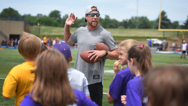 Minnesota Vikings wide receiver Adam Thielen works with kids Friday, June 8, at the football portion of the Legends Sports Clinics at KirkebyÐOver Stadium.