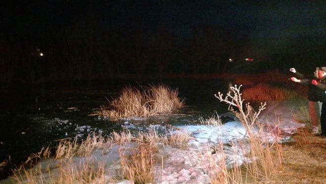 A sheriff's office photo shows the scene in New Harmony on Monday night where a deputy dove into a frozen pond to pull out an 8-year-old who had fallen in.