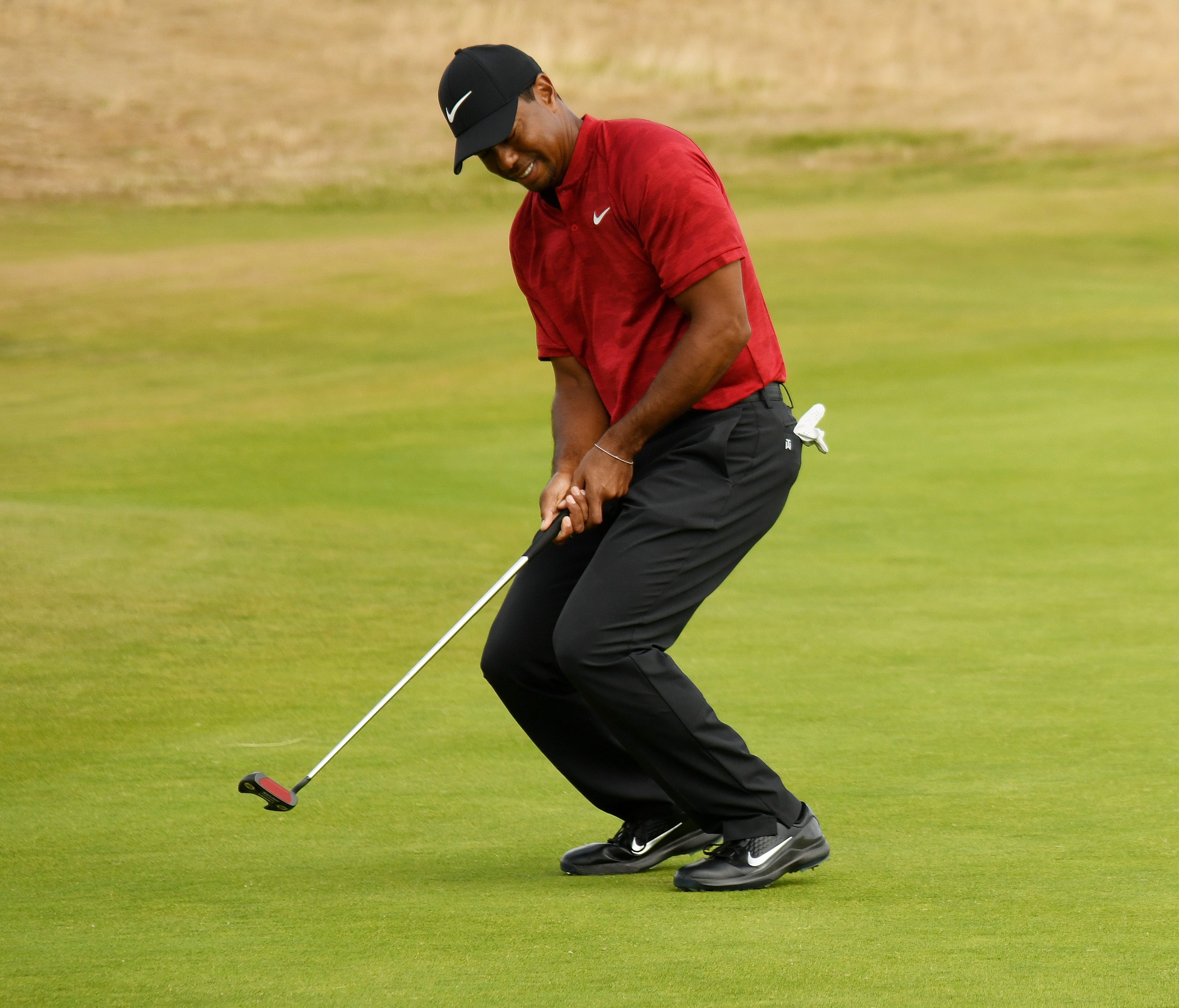 Tiger Woods reacts to a putt for birdie on the first green during the final round of the 147th Open Championship at Carnoustie Golf Club.