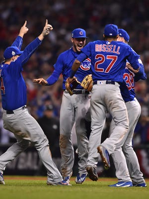 Chicago Cubs players including Anthony Rizzo (left) , Kris Bryant (center) , Addison Russell (right) celebrate after winning Game 7 of the 2016 World Series.
