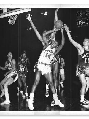 Oscar Robertson's Royals teams often ran into the great Celtics team that included Bill Russell, K.C. Jones (25) and Tommy Heinsohn (15), among others. On this play, on Dec. 3, 1961, Robertson was fouled from behind by Russell.