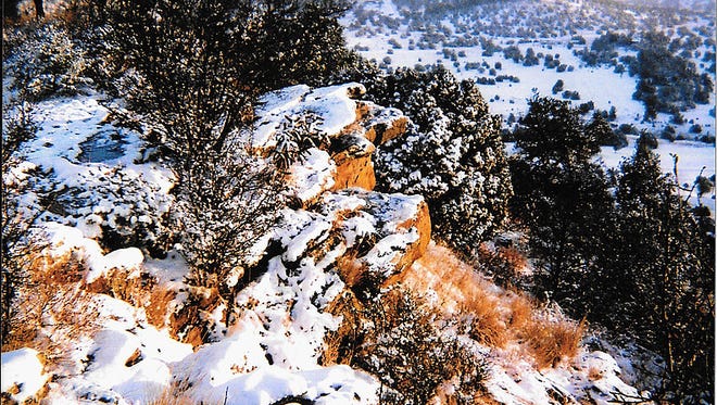 The photograph "Last Snow at Coyote Cliffs" by Neal Jones. An April snow fall decorates the Eastern cliffs.